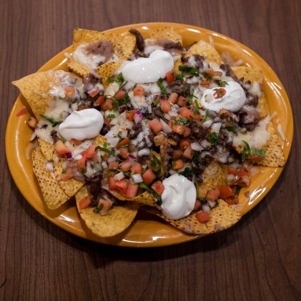 Taxco Mexican Cuisine's nachos with steak, melted cheese, pico de gallo, and sour cream.